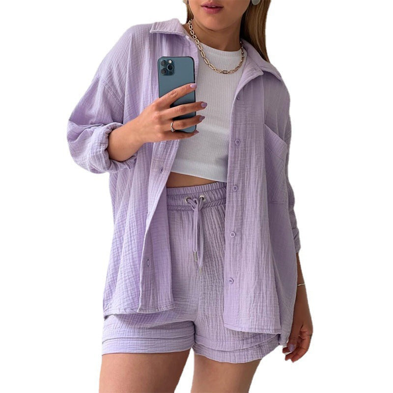 A two-piece set of wrinkled fabric shirt and high-waisted shorts