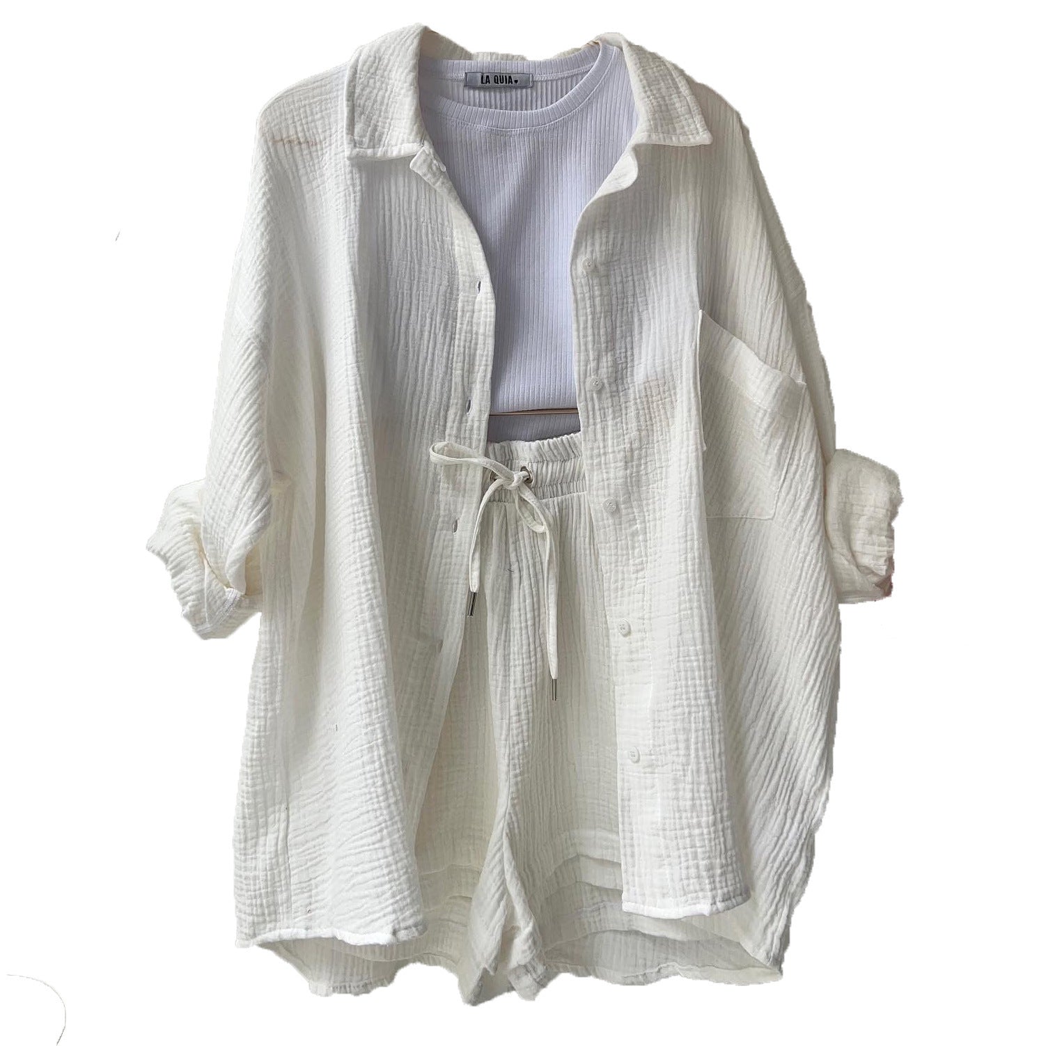 A two-piece set of wrinkled fabric shirt and high-waisted shorts