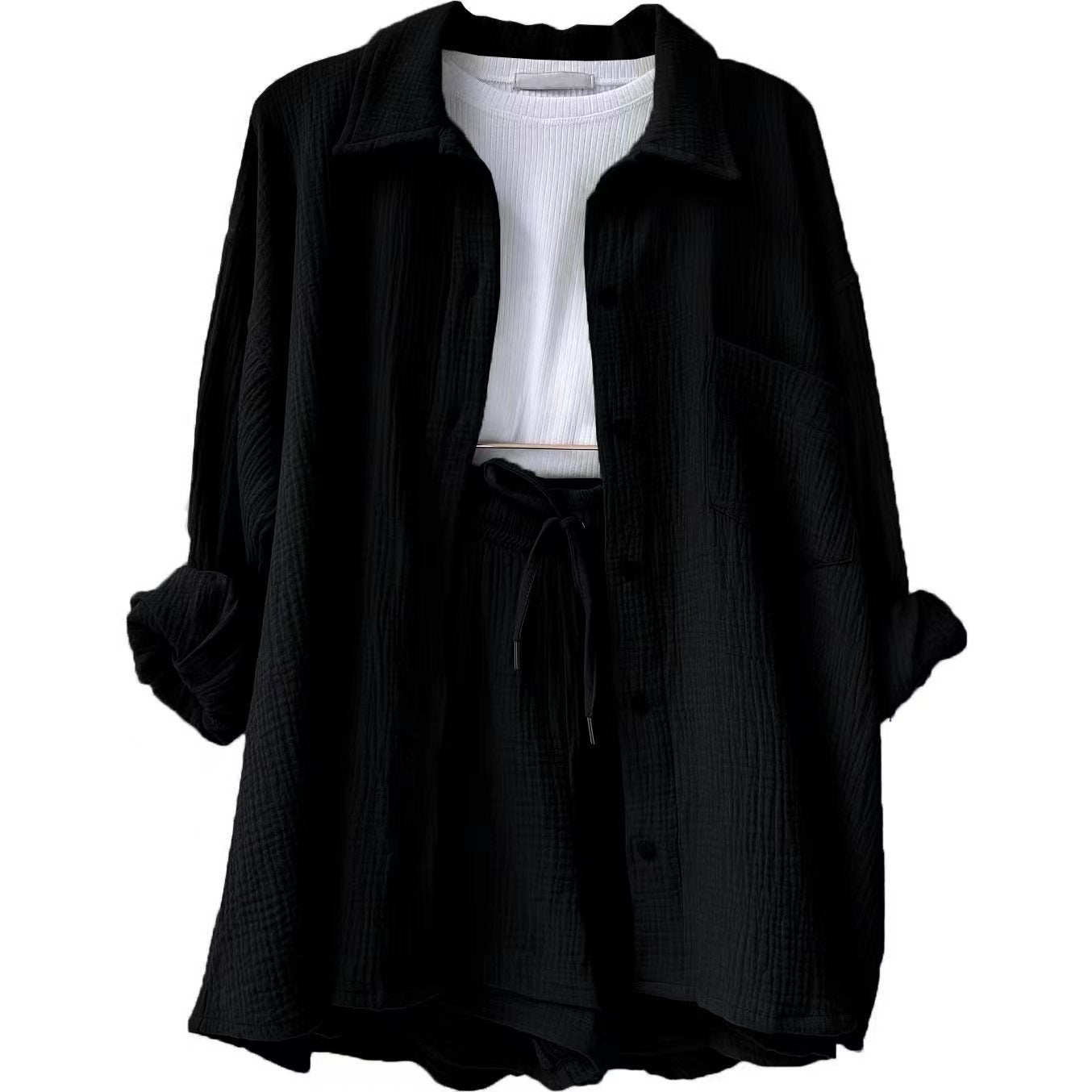 A two-piece set of wrinkled fabric shirt and high-waisted shorts