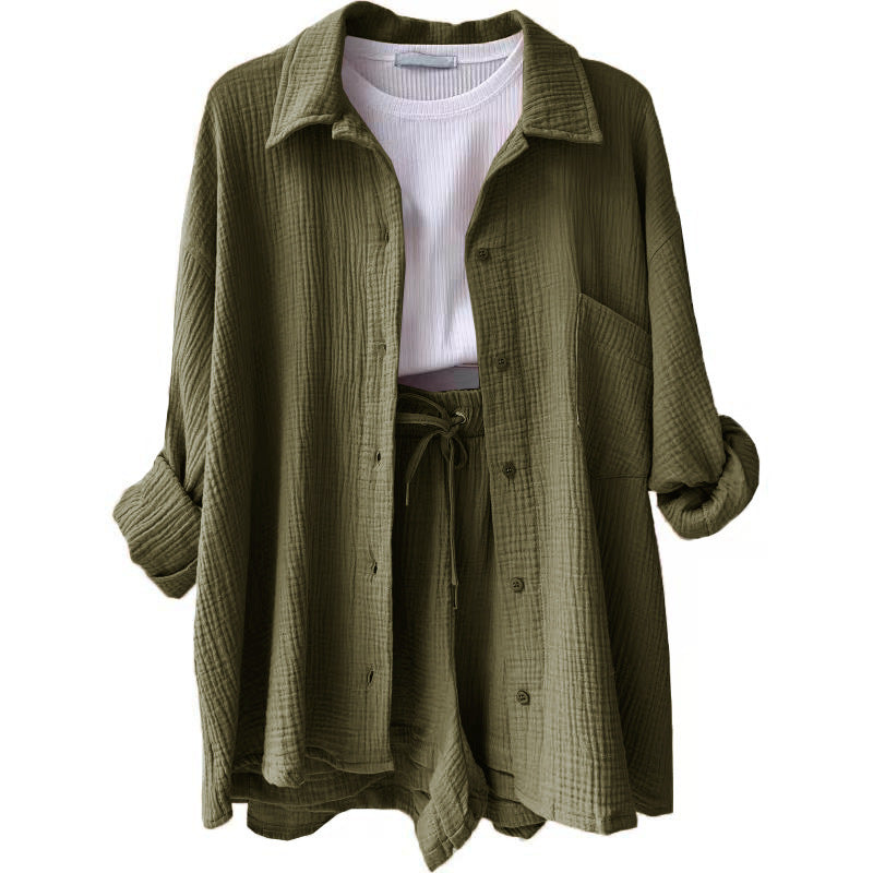A two-piece set of wrinkled fabric shirt and high-waisted shorts