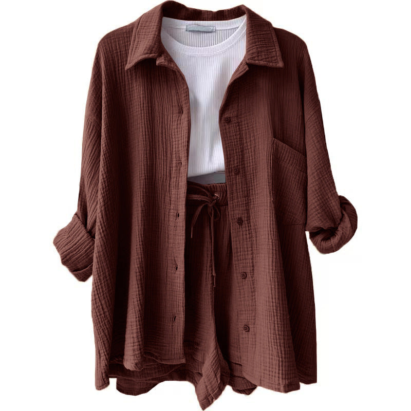A two-piece set of wrinkled fabric shirt and high-waisted shorts