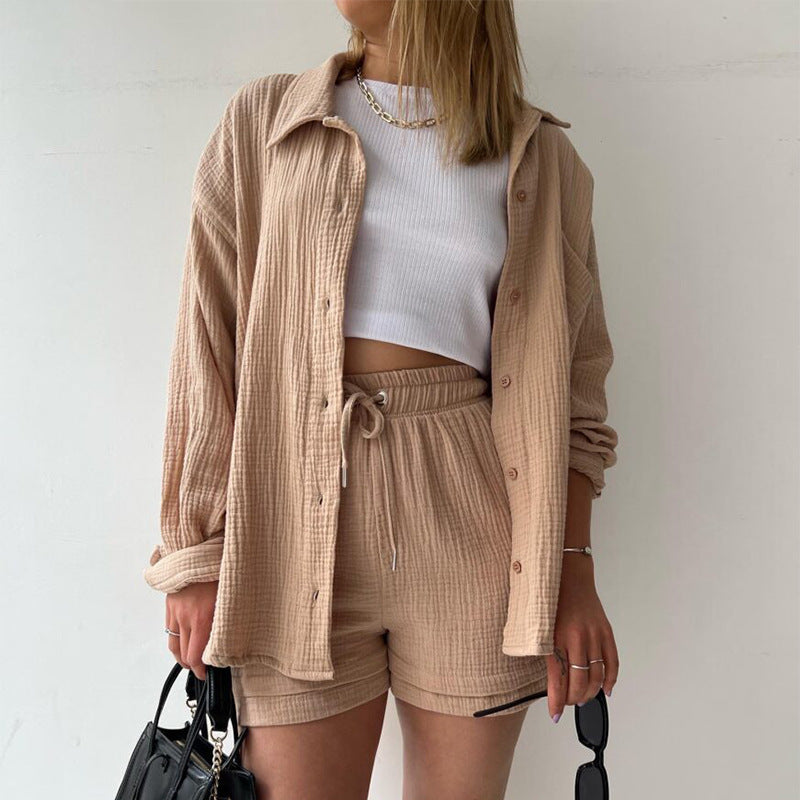 A two-piece set of wrinkled fabric shirt and high-waisted shorts